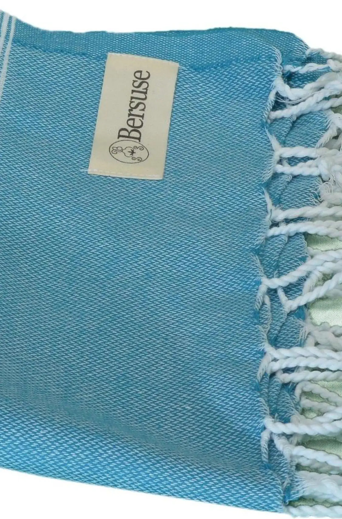 "Light blue cotton label with white fringes, featuring a small tag with 'Bersuse' logo, angled view."
