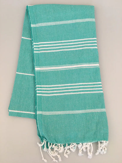 Aphrodisias Sultan Turkish towel in turquoise with white stripes and fringed edges, displayed flat on a light background.