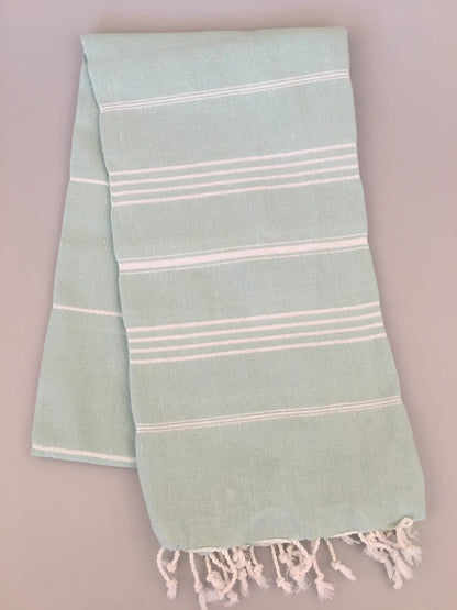 Aphrodisias Sultan Turkish Towel in light green with white stripes and fringed edges, laid flat on a neutral background.
