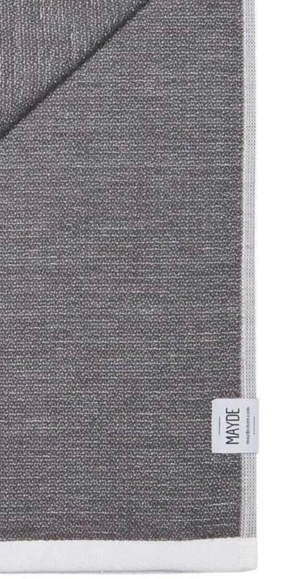 Gray cotton label with a textured pattern, featuring a white edge and a small tag labeled "MADE" at the bottom corner.