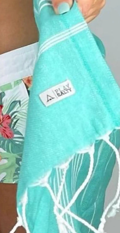 Aqua cotton label with white stripes and fringe, featuring a small rectangular tag with the text "PLAY EMILY."