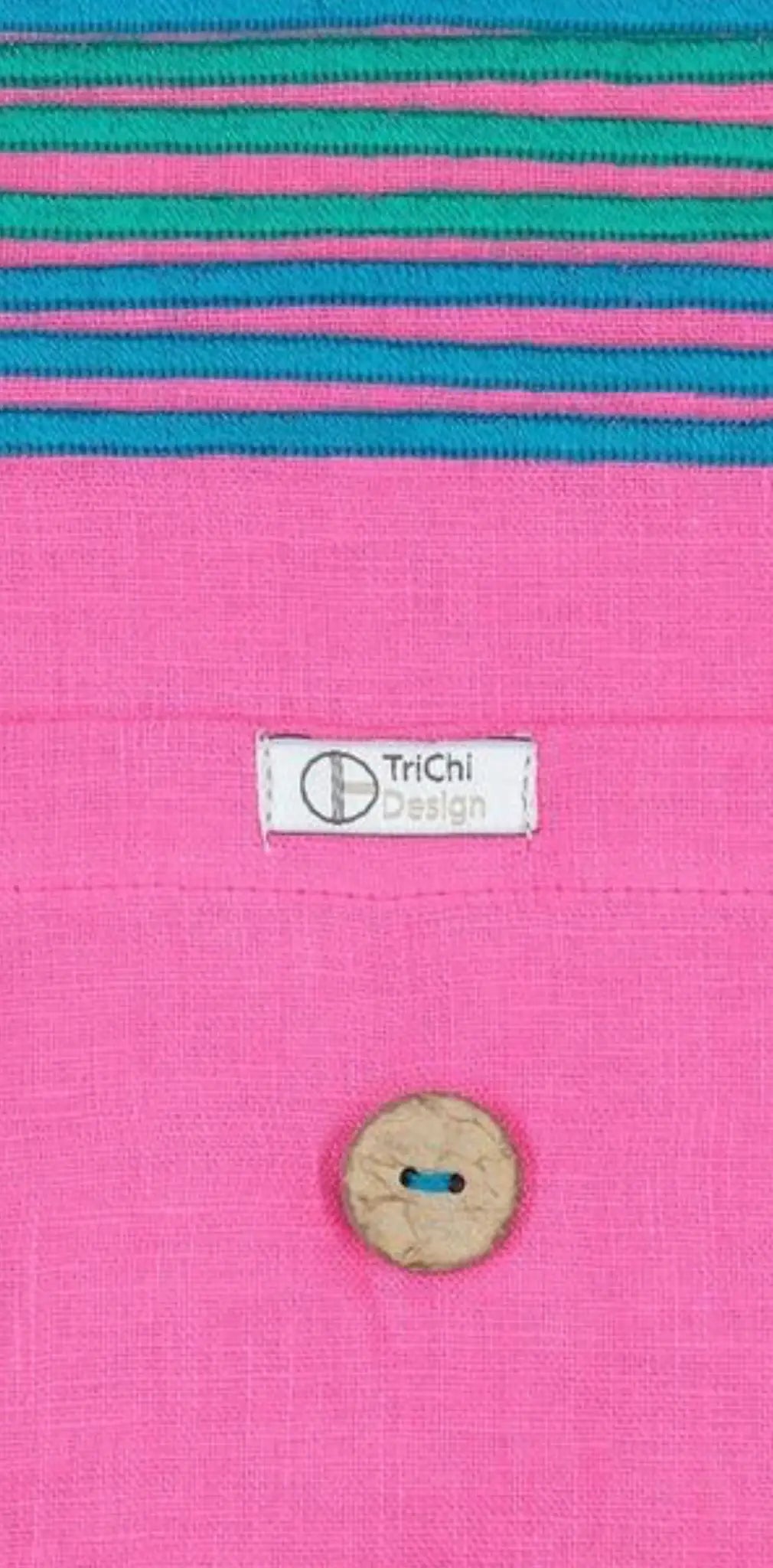 "Custom cotton label with white tag featuring 'TriChi Design,' pink fabric background with colorful striped detail."