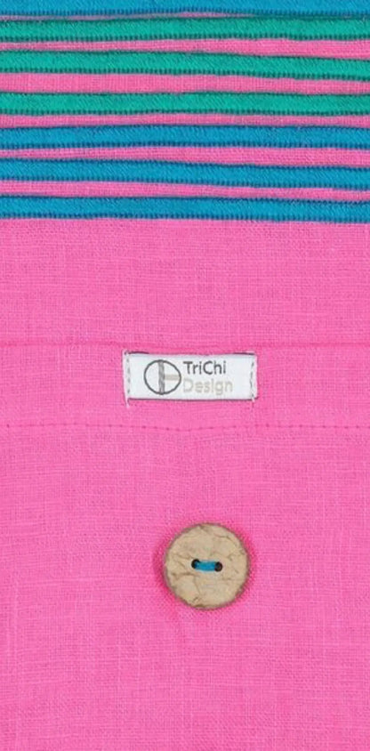"Custom cotton label with white tag featuring 'TriChi Design,' pink fabric background with colorful striped detail."